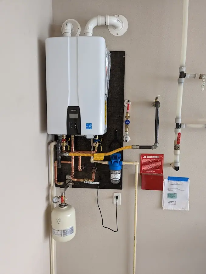 Professional plumber installing copper piping in a Liberty home